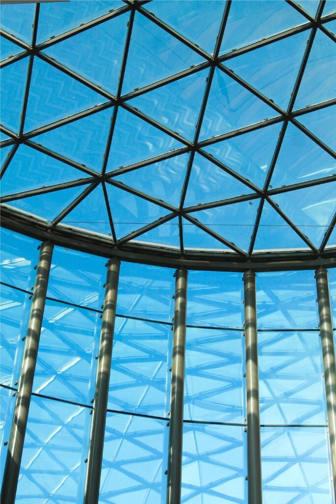 A stunning view of a modern glass ceiling showcasing geometric patterns and natural light.